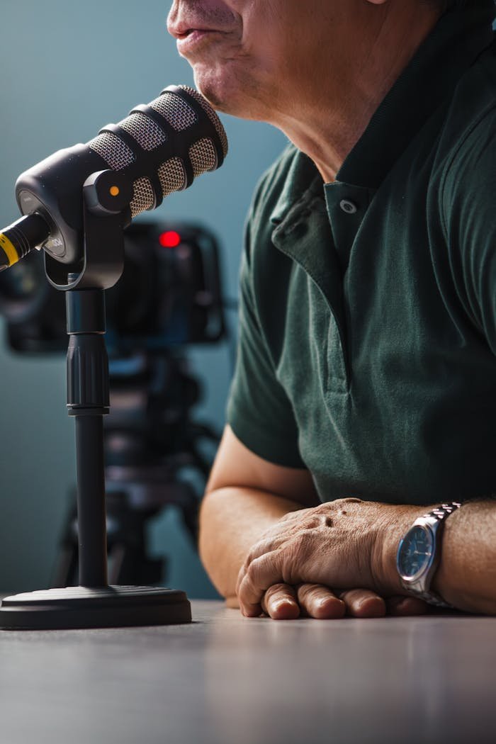 services-04 A detailed view of a professional podcast setup featuring a microphone and video camera, highlighting interview equipment.
